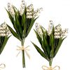 three lily of the valley stem bushes tied with raffia