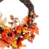 bright artificial autumn wreath with berries, pumpkins and leaves
