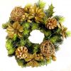 poinsettia candle ring with green foliage and gold pine cones