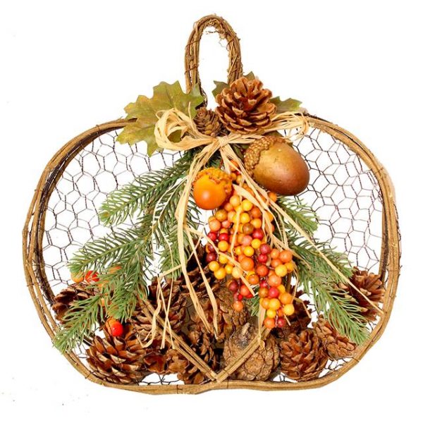 autumn pumpkin decoration full of artificial berries, pine cones and acorns